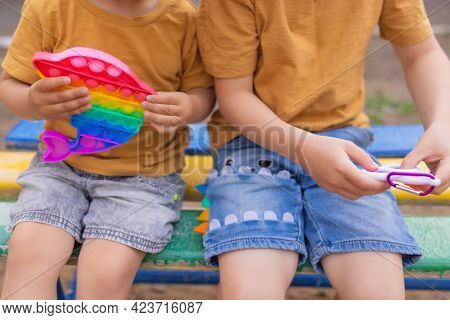 Colorful Antistress Sensory Toy Fidget Push Pop It In Toddlers Hands. Antistress Trendy Pop It Toy. 