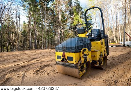 Closeup Of Yellow Compactor Roller, A Machined Used For Compaction Of Soil, Asphalt Surface, Gravel 