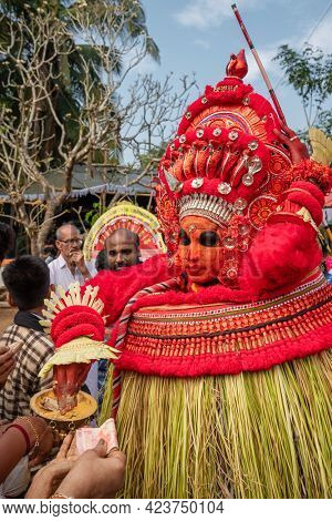 Payyanur, India - December 5, 2019: Theyyam artist perform during temple festival in Payyanur, Kerala, India. Theyyam is a popular ritual form of worship in Kerala, India