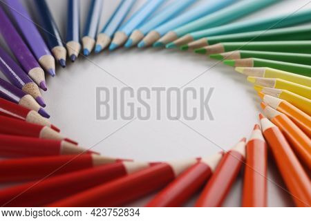 Many Sharp Multicolored Sharp Pencils Lying In Shape Of Circle Closeup Background