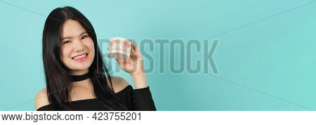 Woman Holding Toothbrush And Dental Teeth Model. Oral Health Care Concept.