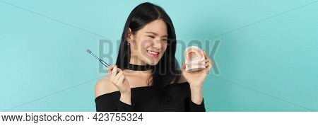 Woman Holding Toothbrush And Dental Teeth Model. Oral Health Care Concept.