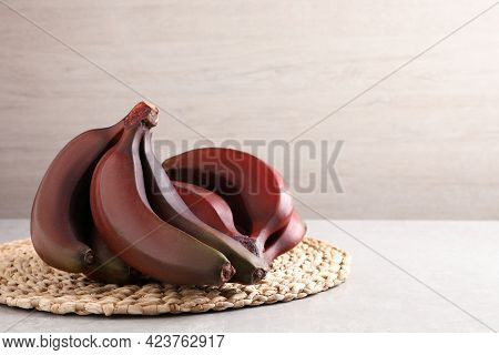 Delicious Red Baby Bananas On Light Table, Space For Text