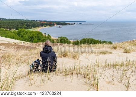 Nida, Lithuania - May 23 2021: Girl Visiting Sand Dunes In Nida, Klaipeda, Lithuania, Europe. Curoni