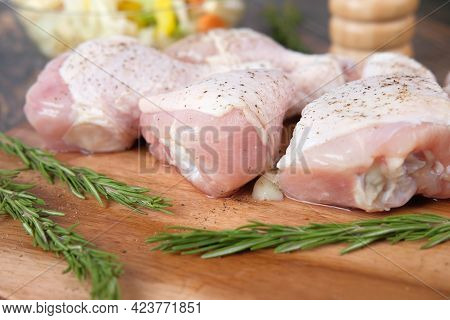 Raw Chicken Drumstick On A Chopping Board
