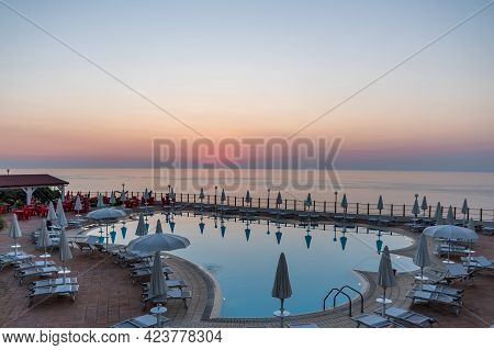 Tropea, Italy, August 2020: Beautiful Swimming Pool At Sunset In A Luxury Resort, Trope As A Popular