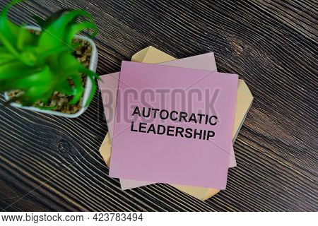 Autocratic Leadership Write On Sticky Notes Isolated On Wooden Table.