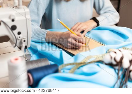 Draws Clothing Design. Workplace Atelier With Notepad. Tailoring Order.