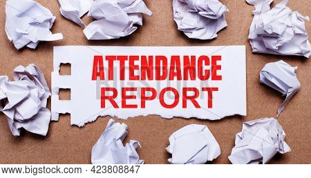 Attendance Report Written On White Paper On A Light Brown Background.
