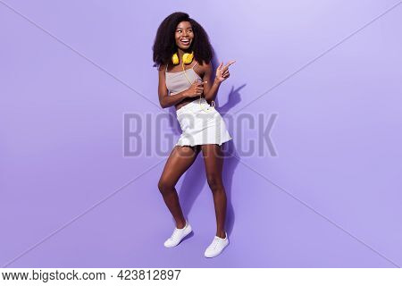 Full Length Body Size View Of Attractive Cheerful Girl Listening Mp3 Showing Copy Space Isolated Ove