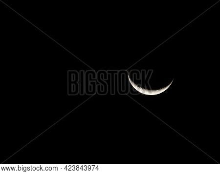 Closeup Of Bright Crescent Moon In Ecuador Showing Fine Detail Of Lunar Surface.