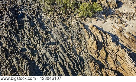 Close Up Of The Texture Of Rocks On A Stoney Coastal Beach At Low Tide Overhead Aerial View