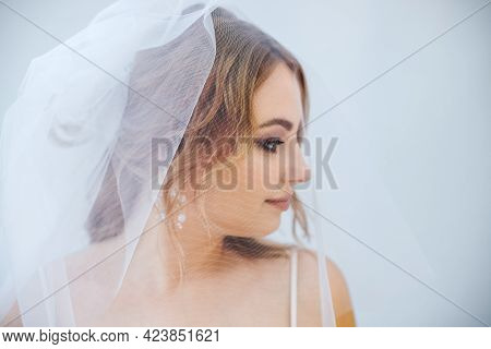Blonde Girl In A Wedding Dress Bride In A White Dress. Makeup.