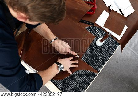 The Hands Of A Master Cut A Piece Of Leather, A Close-up Of A Cut Of A Leather Product A Master Man 