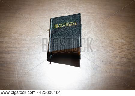 Bible In The Light Wooden Background. The Holy Bible.the Old Holly Bible Closed.black Holly Bible On