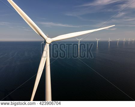 Wind Turbine From An Aerial View, Drone View At Windpark A Windmill Farm In The Lake Ijsselmeer The 
