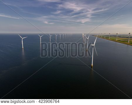 Wind Turbine From An Aerial View, Drone View At Windpark A Windmill Farm In The Lake Ijsselmeer The 