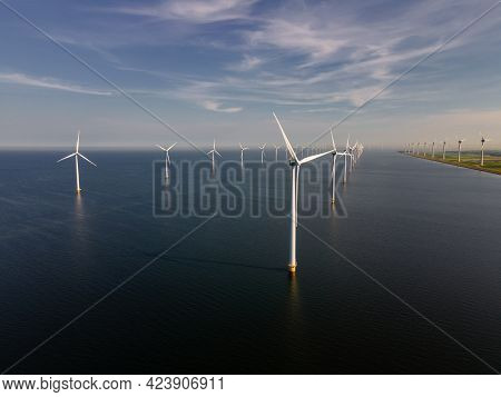 Wind Turbine From An Aerial View, Drone View At Windpark A Windmill Farm In The Lake Ijsselmeer The 