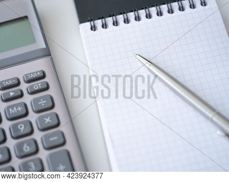 Template With Caculator Pen Notepad On White Table Top View Background.