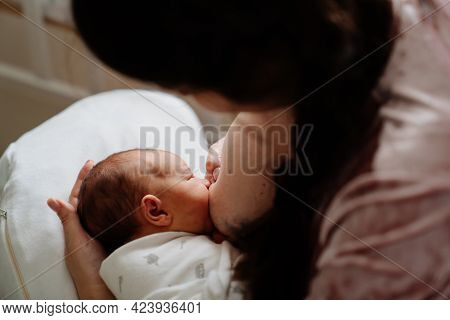 Mother Breastfeeds Newborn Baby. Naturalness And Convenience Of Breastfeeding.