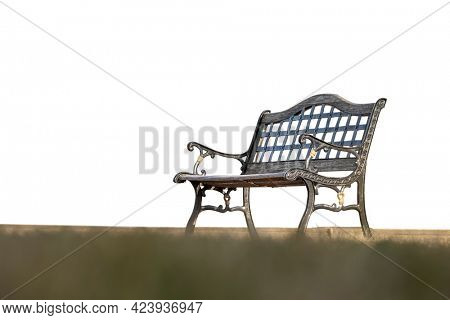 Wrought iron park bench against white background