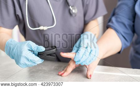 Assessment Of The Respiratory System Function. Measurement Of Blood Saturation And Pulse In An Elder