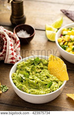 Chunky Homemade Guacamole In A Bowl With Tortilla Chips