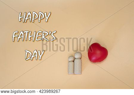 Happy Father\\\'s Day Concept With Two Wooden Figure, A Red Heart And Text.
