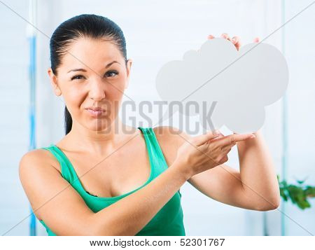 Gloomy young brunette woman holding a white cloud for text