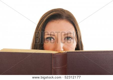 Attractive young girl reading thick old book