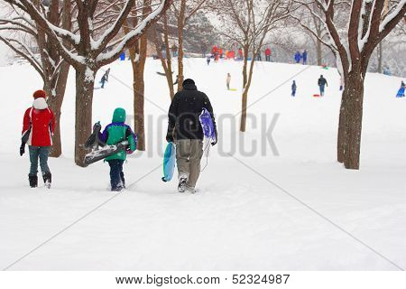 Family walking to the sledding hill