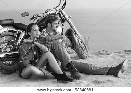 Black and white photo. Biker man and girl