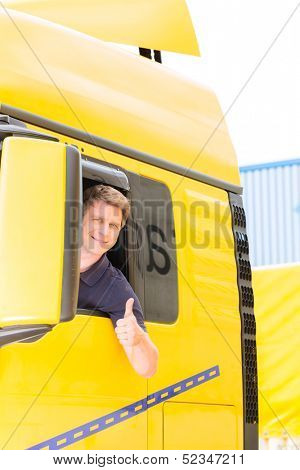 Logistics - proud driver or forwarder in drivers cap of truck and trailer, on a transshipment point