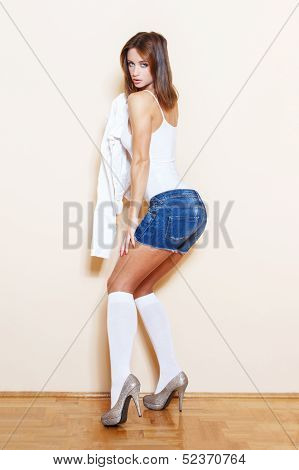 Sexy Brunette Woman Posing At Wall