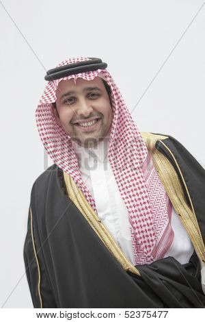 Portrait of smiling young man in traditional Arab clothing and Kaffiyeh