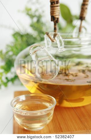Kettle with jasmine tea and a glass cup