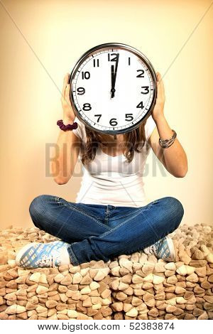 Young girl with an huge clock  on head