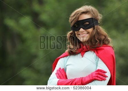 Young woman with red super hero kit smiling