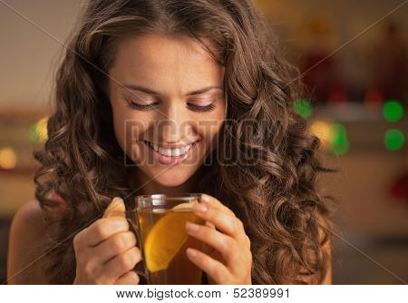 Happy Young Woman Enjoying Drinking Ginger Tea With Lemon