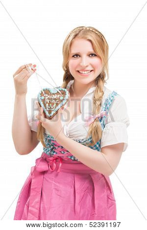 Bavarian woman in dirndl, holding lebkuchen.
