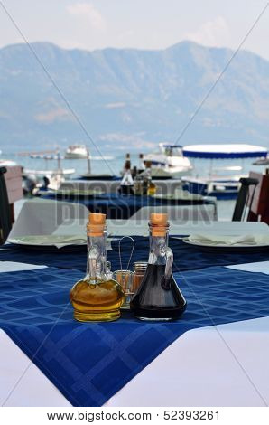 Bottle Of Olive Oil And Italian Balsamic Vinegar On Blue Tablecloth In The Open Air Restaurant On Em