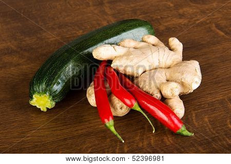 Zucchini, imbir and red hot chilie peppers on kitchen table