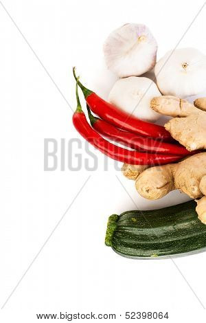 Zucchini, imbir,garlic and red hot chilie peppers over white background. Group of vegetables.