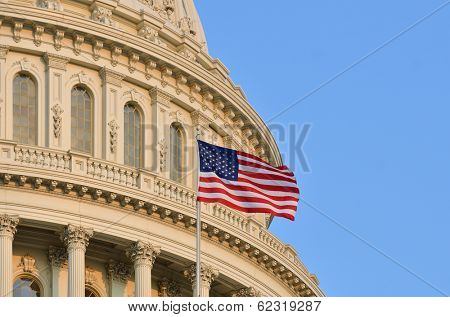 The U.S. Capitol building dome detail and waving American flag - Washington DC 