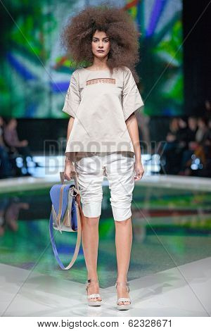 ZAGREB, CROATIA - MARCH 28, 2014: Fashion model wearing clothes designed by Marina Design and Marija Ivanovic bag on the 'Fashion.hr' fashion show