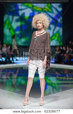 ZAGREB, CROATIA - MARCH 28, 2014: Fashion model wearing clothes designed by Marina Design and Marija Ivanovic jewelry on the 'Fashion.hr' fashion show