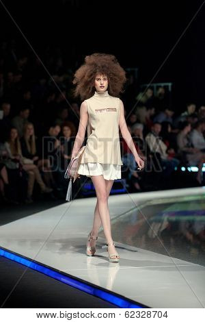ZAGREB, CROATIA - MARCH 28, 2014: Fashion model wearing clothes designed by Marina Design and Marija Ivanovic bag on the 'Fashion.hr' fashion show