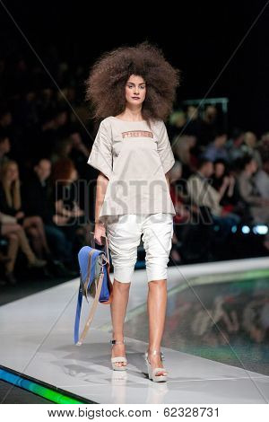 ZAGREB, CROATIA - MARCH 28, 2014: Fashion model wearing clothes designed by Marina Design and Marija Ivanovic bag on the 'Fashion.hr' fashion show