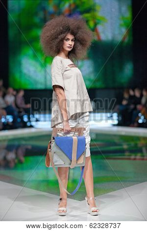 ZAGREB, CROATIA - MARCH 28, 2014: Fashion model wearing clothes designed by Marina Design and Marija Ivanovic bag on the 'Fashion.hr' fashion show