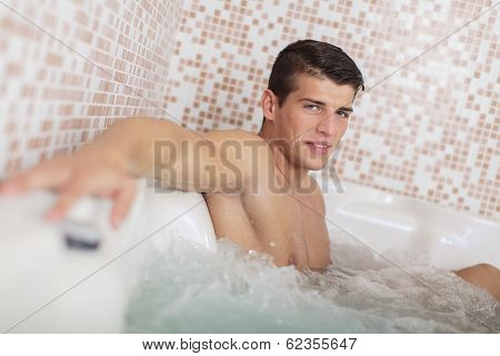Young Man Relaxing In The Hot Tub